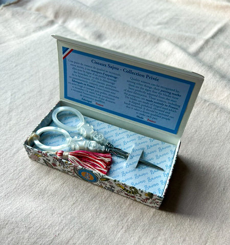 Maison Sajou mother-of-pearl style cross embroidery scissors handcrafted in France with precision steel blades, decorative tassel, and elegant cross-shaped handles.